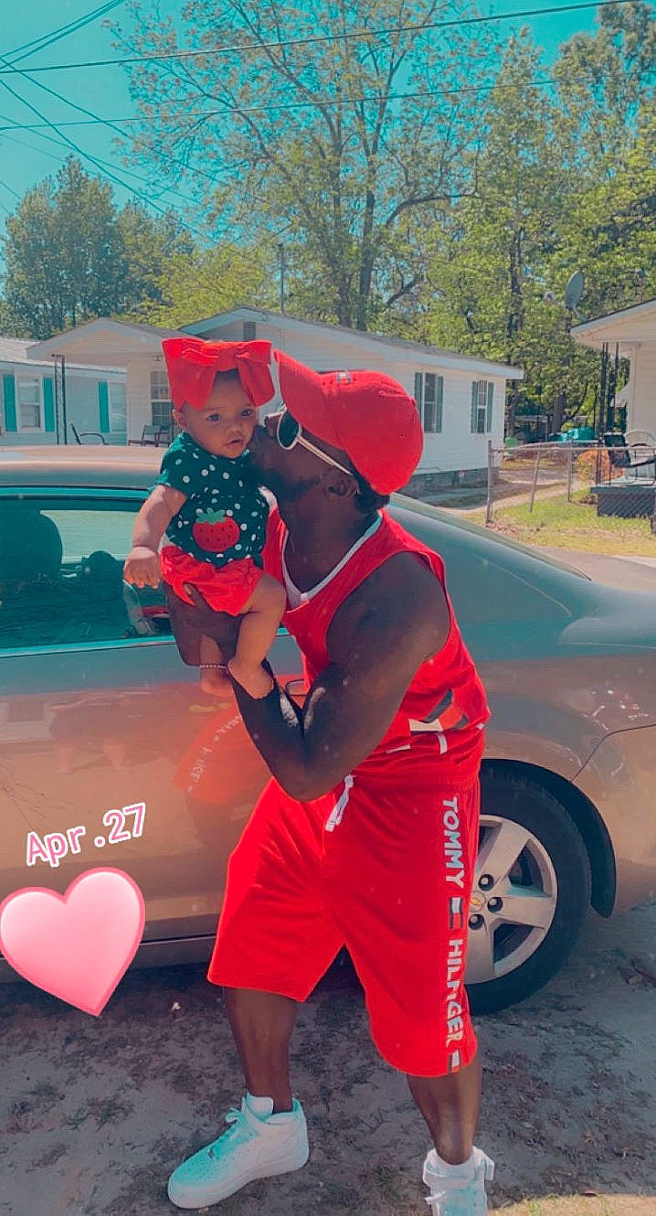 Ryleah is registered to the contest to win money with this photo: automotive_tire, baseball_cap, cap, car, cool, electric_blue, eyewear, happy, hat, headgear, headwear, magenta, person, pink, red, shorts, street_fashion, t_shirt, tire, tree