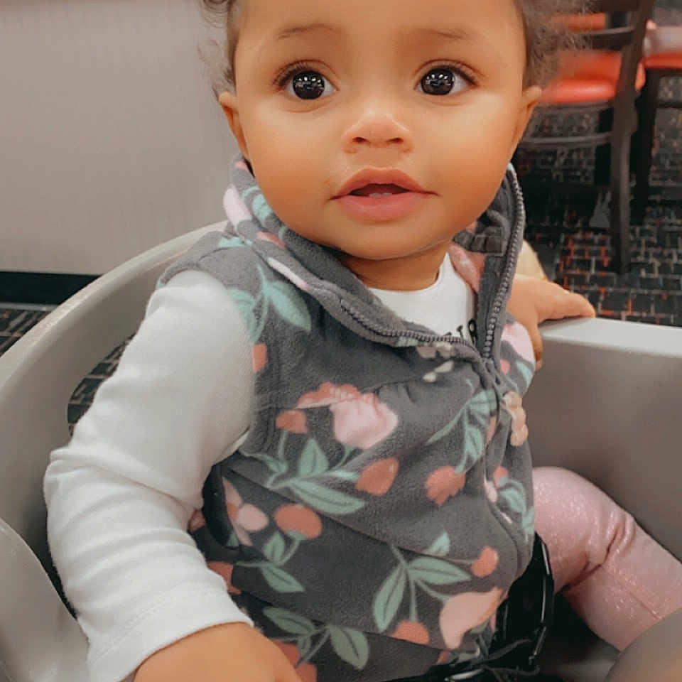 Ryleah joined the competition — help win amazing prizes! baby, baby_toddler_clothing, chair, cheek, child, comfort, eye, eyebrow, eyelash, face, fun, happy, iris, lip, nose, sitting, skin, sleeve, thumb, toddler