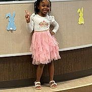 Tina joined the competition — help win amazing prizes! bunny_cutouts, casual, child, cute, decorations, girl, happy, indoor, peace_sign, person, pink_skirt, plants, portrait, posing, reception_desk, sandals, smiling, standing, white_top, young
