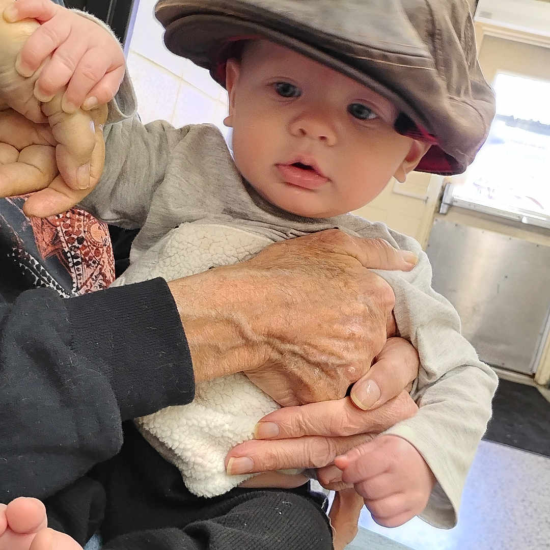 Heartley joined the competition — help win amazing prizes! baby, cap, casual, child, clothing, curious, door, expression, face, foot, hands, hat, holding, indoor, jeans, person, seated, sign, skin, sleeve