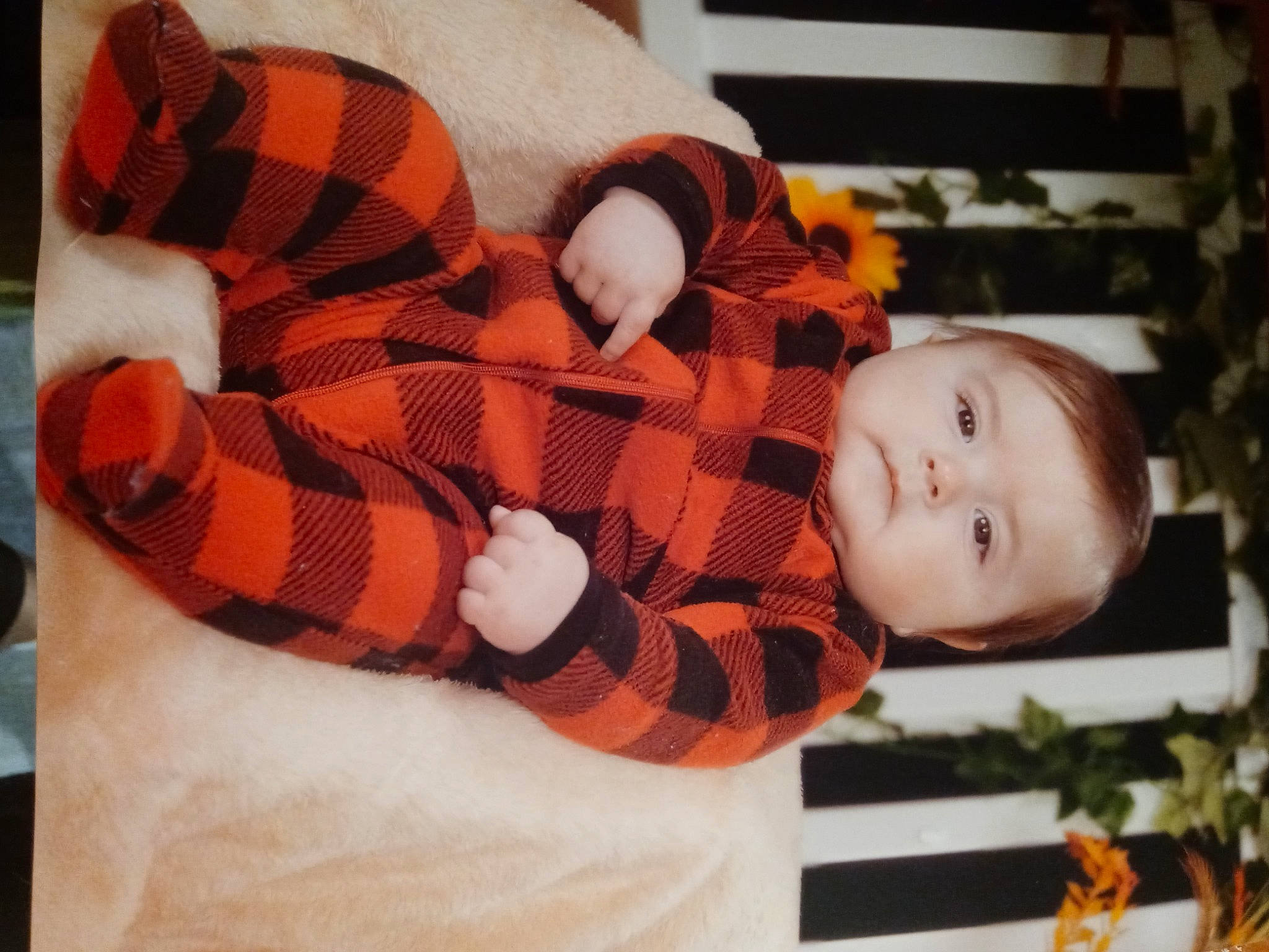 Luke is registered to the contest to win money with this photo: baby, baby_products, baby_toddler_clothing, carmine, child, comfort, fur, happy, orange, pattern, person, plaid, plant, sleeve, stuffed_toy, tartan, textile, toddler, toy, tree