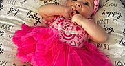 Charlotte joined the competition — help win amazing prizes! baby, child, clothing, cute, face, fingers, happy, headband, infant, joy, love, lying_down, pillow, pink, sitting, smiling, text, three_months, tutu, wooden_plaque