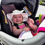 Charlotte joined the competition — help win amazing prizes! baby, child, stroller, hat, smile, happy, infant, toy, blanket, outdoor, sunlight, cute, clothing, seat, baby_accessory, foot, hand, person, portrait, daylight