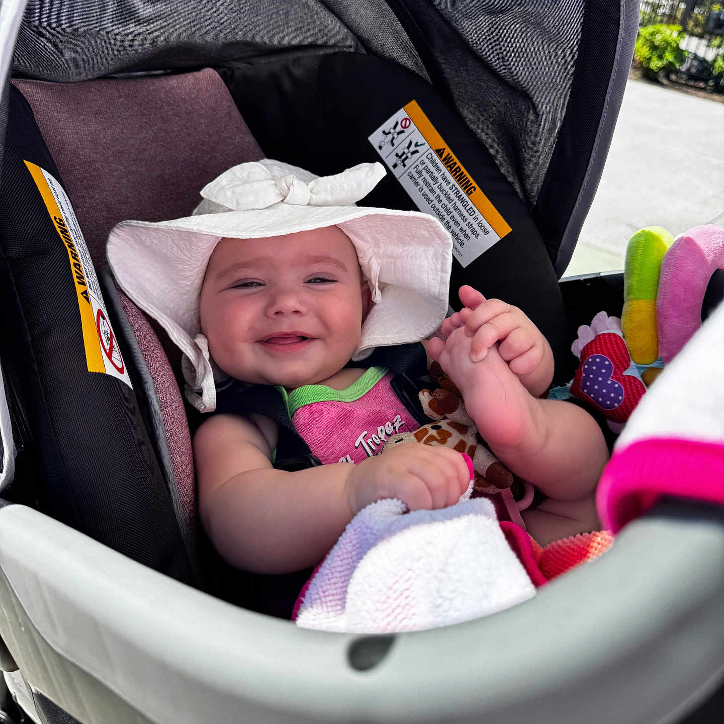 Charlotte joined the competition — help win amazing prizes! baby, child, stroller, hat, smile, happy, infant, toy, blanket, outdoor, sunlight, cute, clothing, seat, baby_accessory, foot, hand, person, portrait, daylight