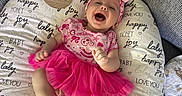 Charlotte is registered to the contest to win money with this photo: baby, infant, smiling, laughing, pink_tutu, headband, cushion, three_months, happy, joyful, clothing, fabric, indoor, person, cute, portrait, sitting, baby_girl, soft_texture, couch