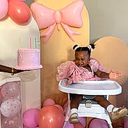 Alia joined the competition — help win amazing prizes! child, toddler, high_chair, birthday_cake, balloons, pink_dress, party, celebration, smiling, happy, indoor, decorations, person, footwear, hair_bows, table, pastel_colors, celebrant, event, presenting
