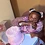 Alia is registered to the contest to win money with this photo: baby, child, cake, pink_dress, high_chair, frosting, birthday, party, celebration, messy, cute, food, happy, hand, face, sitting, indoor, person, fun, toddler