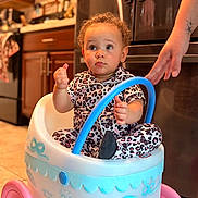 Autumn joined the competition — help win amazing prizes! toddler, child, pajamas, toy_stroller, indoor, kitchen, curly_hair, person, hand, floor, cabinet, appliance, pink_wheels, blue_handle, patterned_clothing, expression, cute, baby, tattoo, playtime