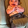 baby, infant, smiling, happy, cute, clothing, denim_shorts, heart_pattern, baby_seat, cushion, comfort, socks, striped_socks, hands, face, eyes, mouth, skin, indoor, portrait