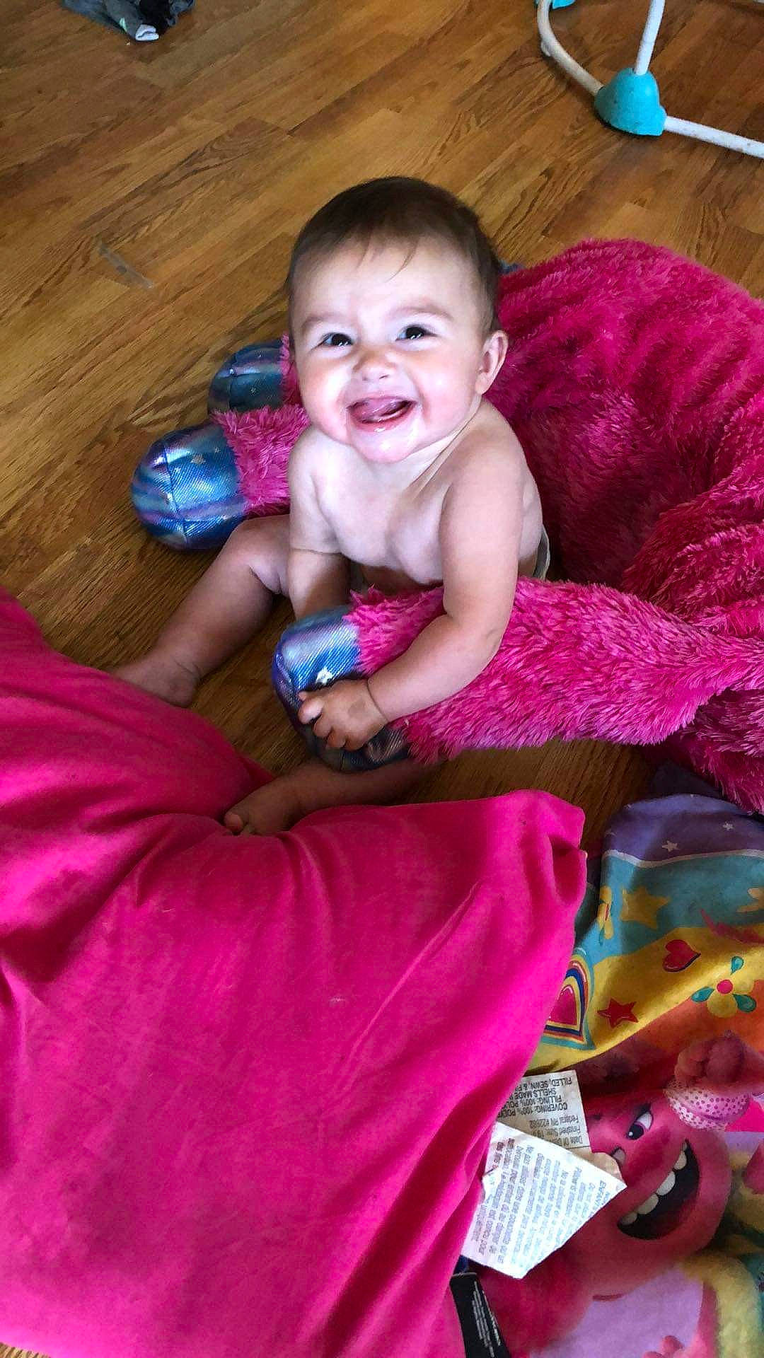 Eyvey is registered to the contest to win money with this photo: baby, baby_toddler_clothing, child, comfort, face, fun, happy, head, iris, joy, linens, magenta, person, pink, purple, skin, smile, textile, thumb, toddler