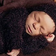 Oakland joined the competition — help win amazing prizes! baby, newborn, sleeping, knitted_clothing, brown, cozy, infant, soft_texture, portrait, cute, peaceful, child, closeup, resting, wrapped, warm, tiny_hand, headwear, sleep, blanket
