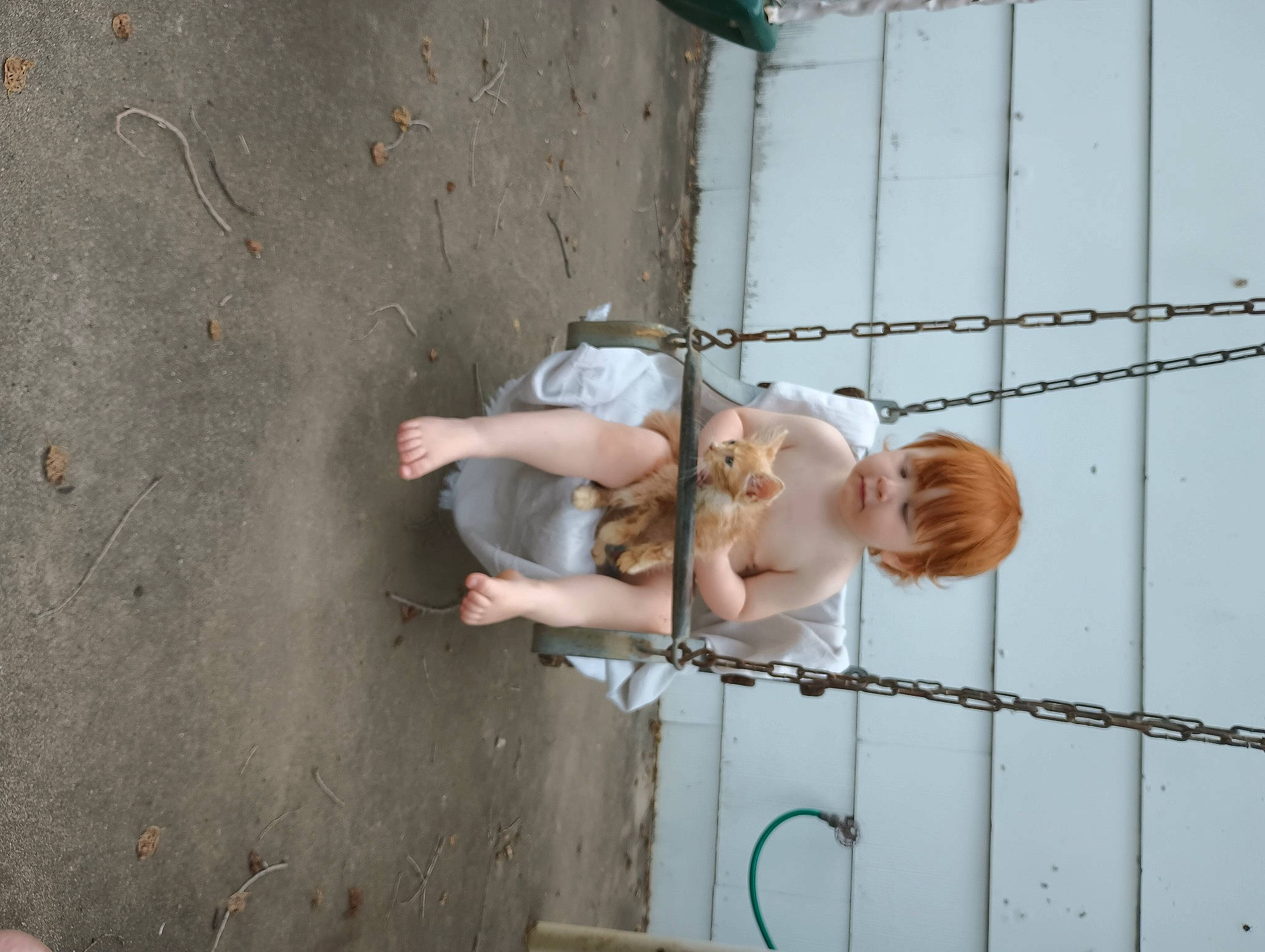 Snickers is registered to the contest to win money with this photo: barechested, child, concrete, elbow, electrical_supply, fence, hand, happy, human_leg, leg, metal, rust, toddler, water, wire, wood