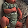 baby, sleeping, bed, onesie, yellow_socks, infant, peaceful, timestamp, human, child, resting, cute, indoor, soft_lighting, portrait, young, person, relaxation, cozy, clothing