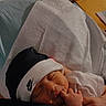 newborn, baby, sleeping, hat, nike, black_hat, white_blanket, infant, cute, peaceful, hand, finger, closeup, indoors, soft_light, face, resting, portrait, tiny, cozy