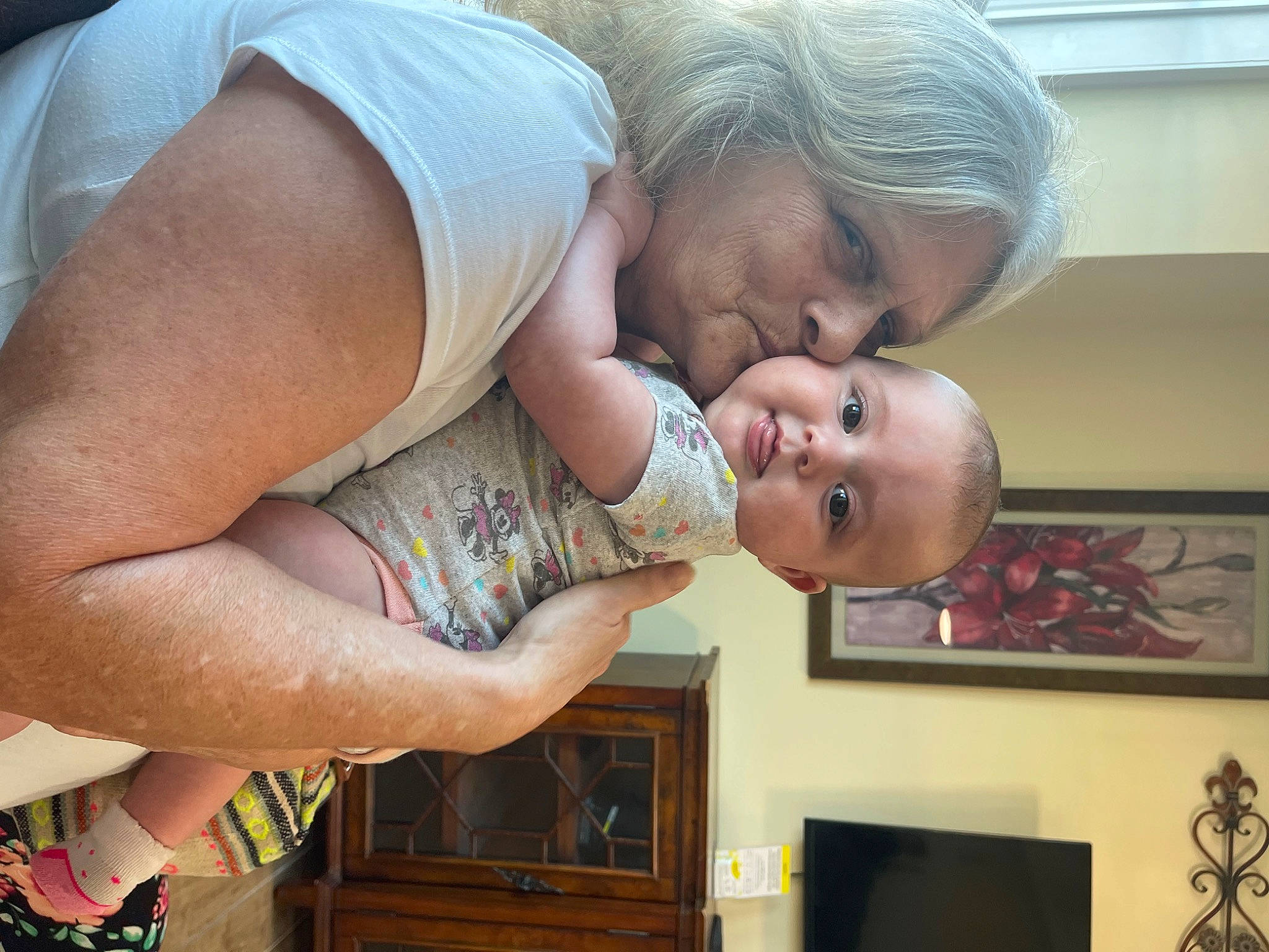 Daniella is registered to the contest to win money with this photo: abdomen, baby, child, elbow, fun, gesture, happy, organ, person, picture_frame, room, sitting, smile, t_shirt, television, toddler, vacation, visual_arts