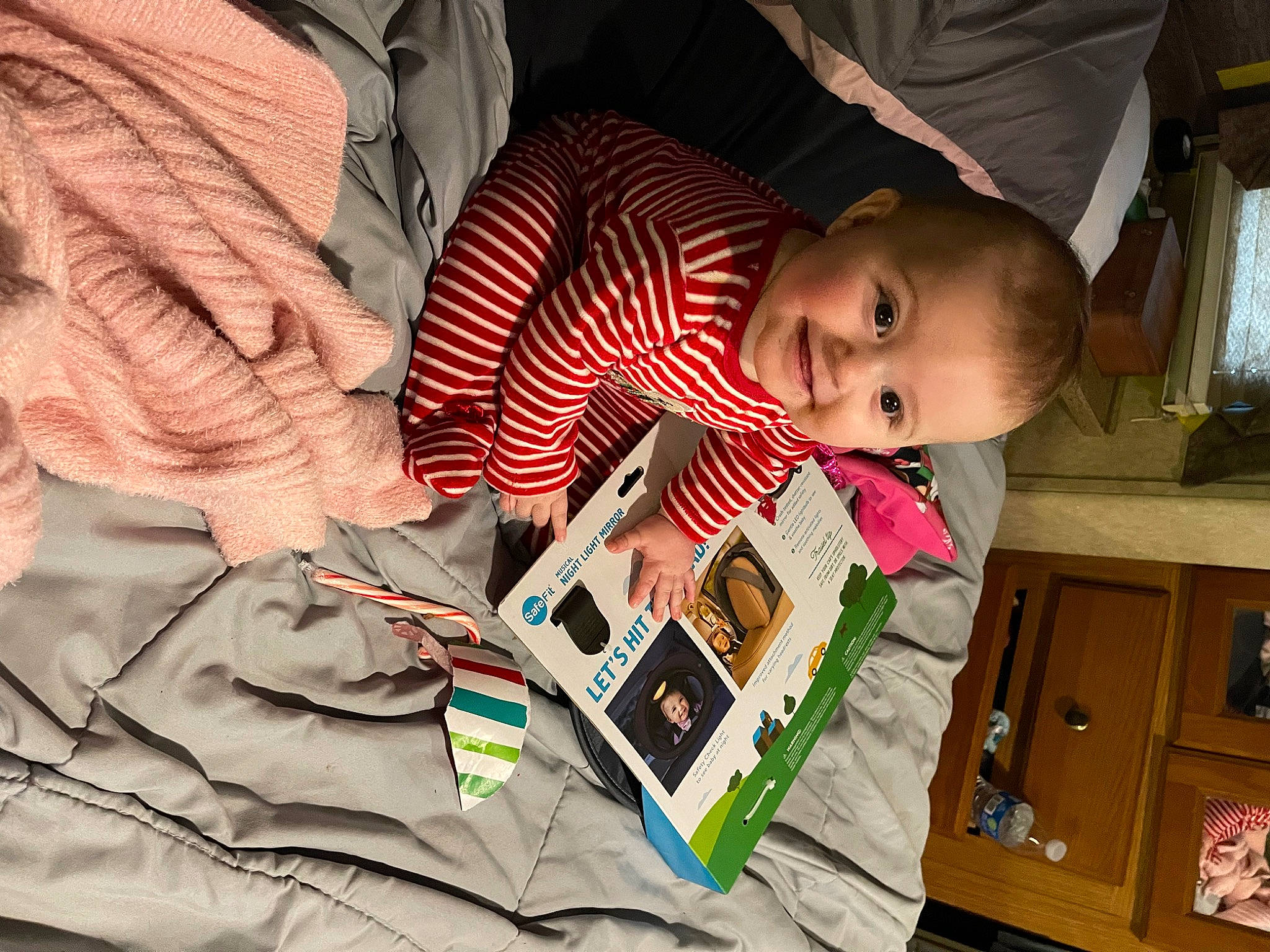 Daniella is registered to the contest to win money with this photo: baby, baby_products, child, door, fun, happy, joy, lap, office_equipment, pattern, people, person, play, reading, room, sitting, smile, t_shirt, toddler, wood