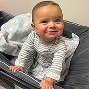 Kolson joined the competition — help win amazing prizes! baby, child, smiling, face, hands, onesie, blanket, bassinet, indoor, cute, young, infant, happy, portrait, skin, clothing, person, bedroom, holding, cozy