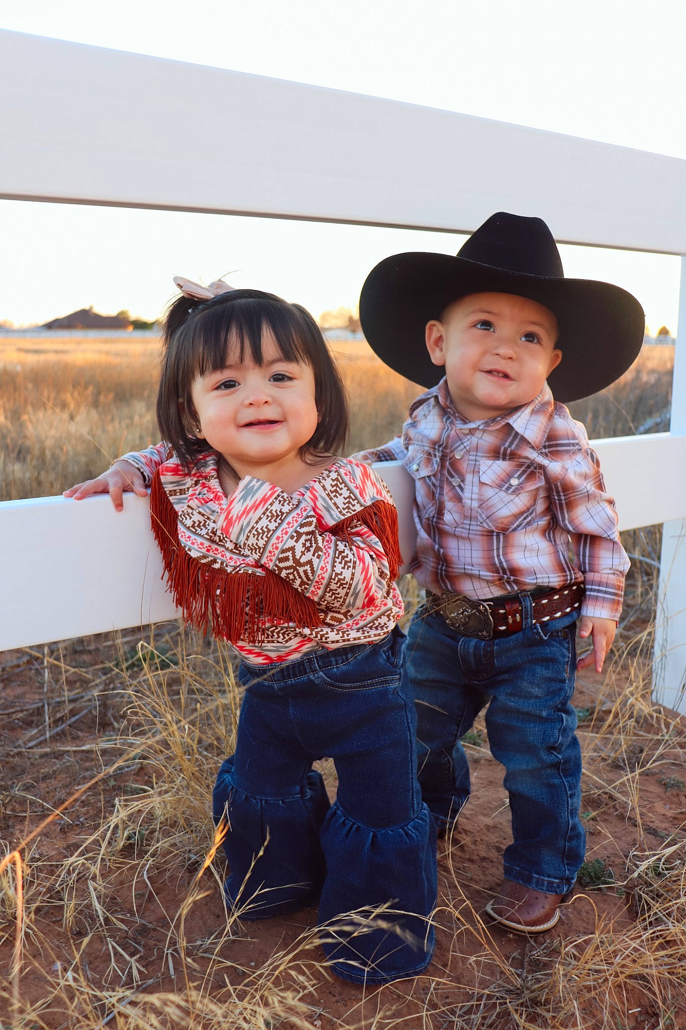 Elian joined the competition — help win amazing prizes! agriculture, baby_toddler_clothing, child, event, field, fun, grass, grassland, happy, hat, headwear, jeans, joy, landscape, people_in_nature, person, prairie, rural_area, sitting, smile