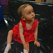 Alexia a rejoint le concours — aidez-le/la à gagner de superbes lots ! baby, black_mat, casual_clothing, child, colorful, curious, cute, floor, foam_blocks, indoor, looking_up, person, play_area, playground, red_dress, sitting, socks, soft_play, toddler, young_child