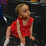 baby, black_mat, casual_clothing, child, colorful, curious, cute, floor, foam_blocks, indoor, looking_up, person, play_area, playground, red_dress, sitting, socks, soft_play, toddler, young_child