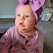 Autumn joined the competition — help win amazing prizes! baby, child, indoor, purple, headband, bow, clothing, face, portrait, curious, soft_lighting, infant, cute, person, sitting, closeup, expression, home, carpet, furniture