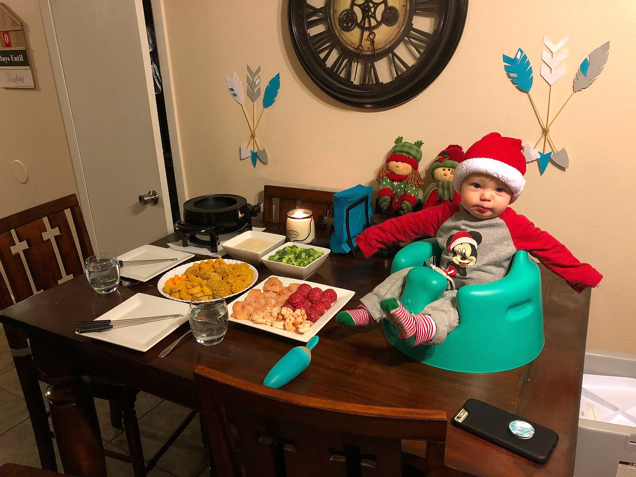 Gideon is registered to the contest to win money with this photo: baby, chair, clock, cuisine, dish, event, fast_food, food, furniture, hat, headwear, holiday, ingredient, interior_design, person, picture_frame, plate, recipe, room, table