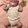 Marilyn joined the competition — help win amazing prizes! adorable, baby, blanket, child, clothing, cute, flower_shaped_sign, headband, infant, lying_down, milestone, newborn, pacifier, pink, portrait, romper, skin, socks, soft_texture, wooden_sign