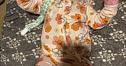 Marilyn joined the competition — help win amazing prizes! baby, bed, blanket, child, cozy, floral_pattern, flowers, halloween, headband, indoors, infant, lying_down, onesie, pacifier, plush_toy, portrait, pumpkin, smiling, text_on_toy, toy
