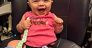 Marilyn joined the competition — help win amazing prizes! baby, child, infant, smiling, happy, laughing, portrait, car_seat, vehicle, seated, pink_shirt, clothing, blanket, plush_toy, pacifier, toy, indoor, close_up, face, joy