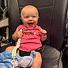 baby, blanket, car_seat, child, close_up, clothing, face, happy, indoor, infant, joy, laughing, pacifier, pink_shirt, plush_toy, portrait, seated, smiling, toy, vehicle