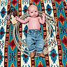 baby, infant, denim_jeans, boots, rope, leather_accessory, patterned_blanket, colorful, one_month_tag, milestone, portrait, lying_down, cute, western_style, newborn, child, face, hands, feet, baby_clothing