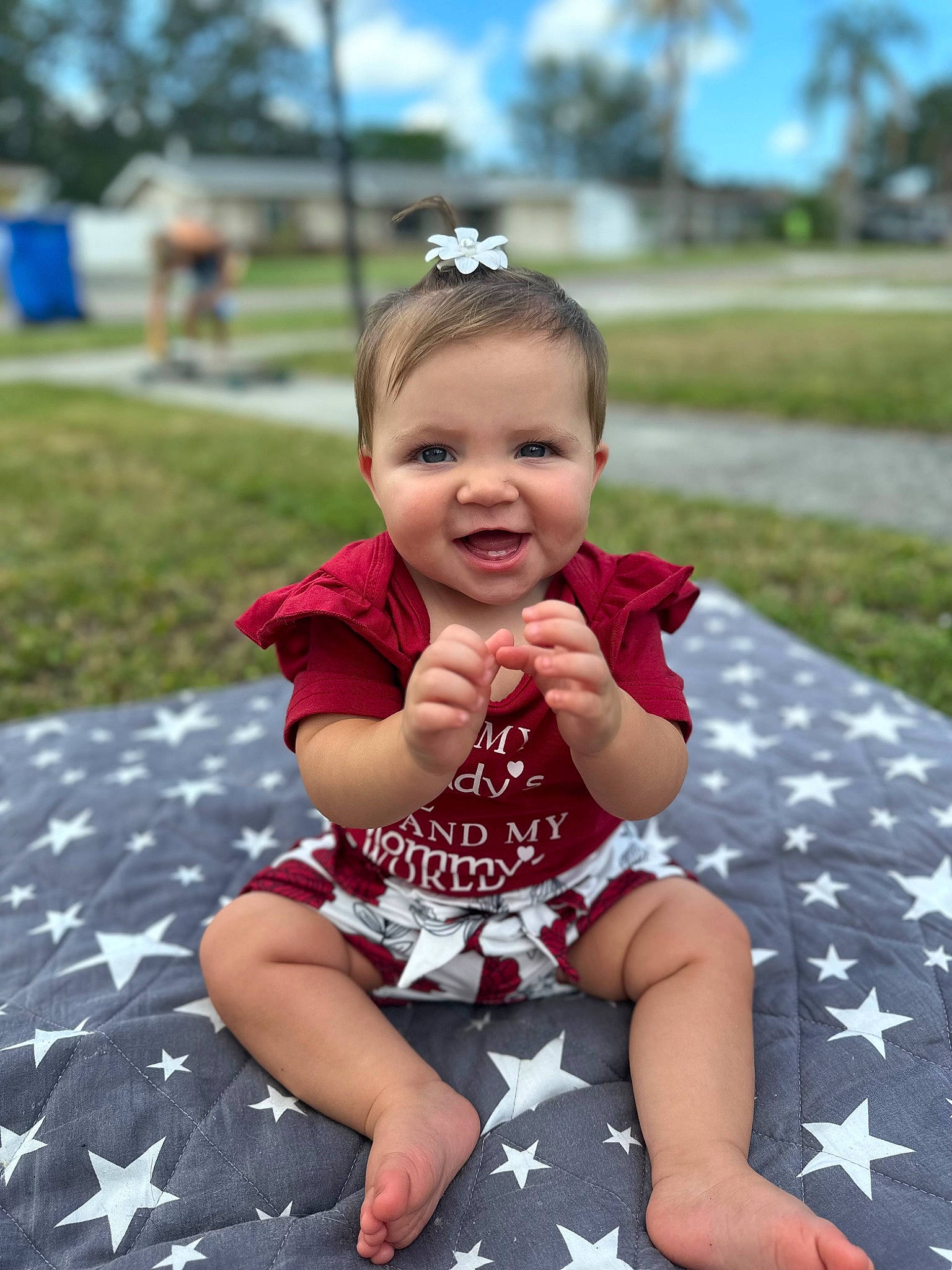 Saylor joined the competition — help win amazing prizes! baby, baby_toddler_clothing, child, fun, grass, happy, joy, leisure, pattern, people, person, pink, plant, recreation, shorts, sitting, skin, sky, sleeve, smile