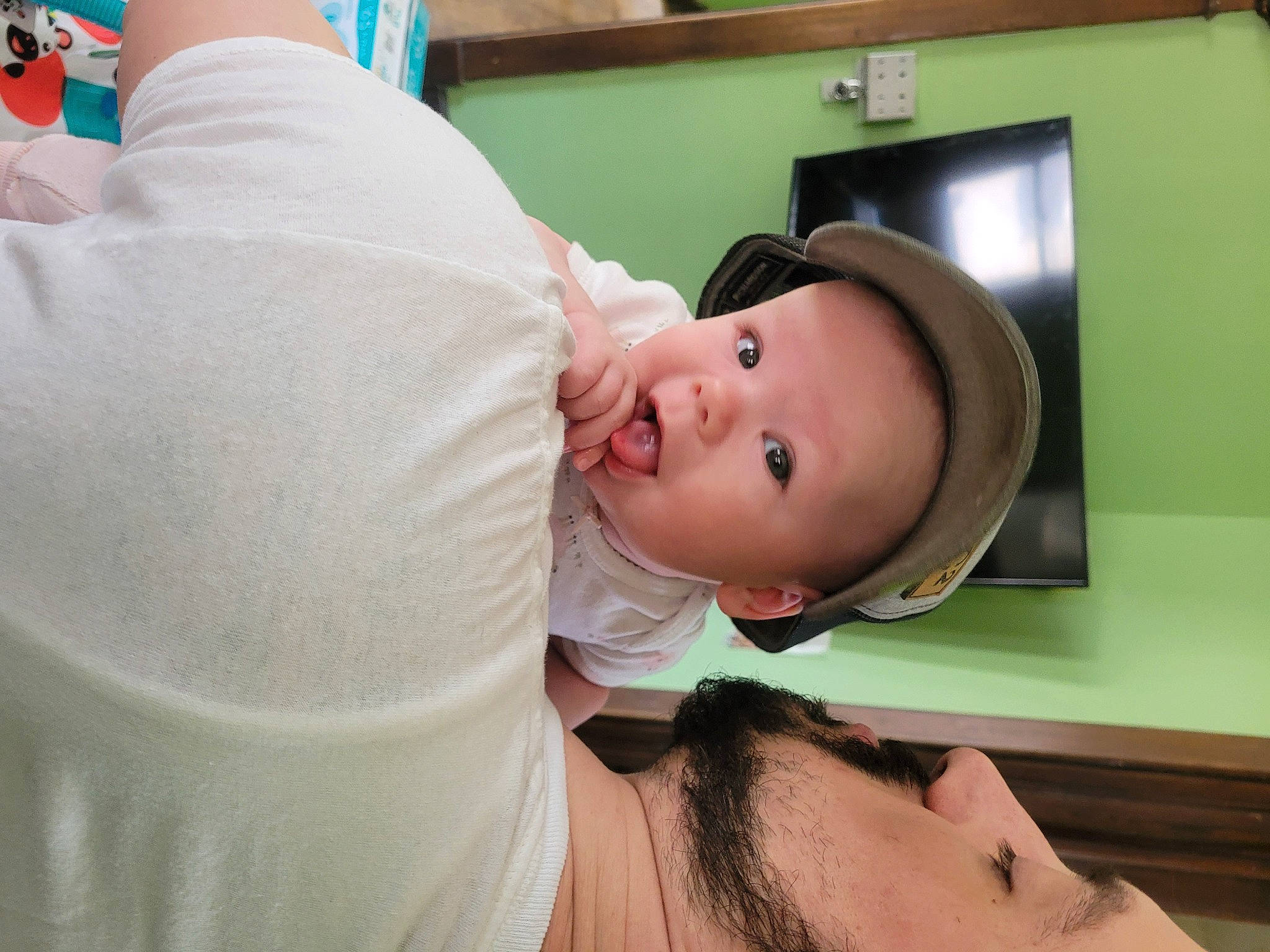 Vivian is registered to the contest to win money with this photo: abdomen, baby, chest, child, comfort, event, eyelash, fun, happy, hat, hospital, mouth, person, picture_frame, room, smile, television, toddler