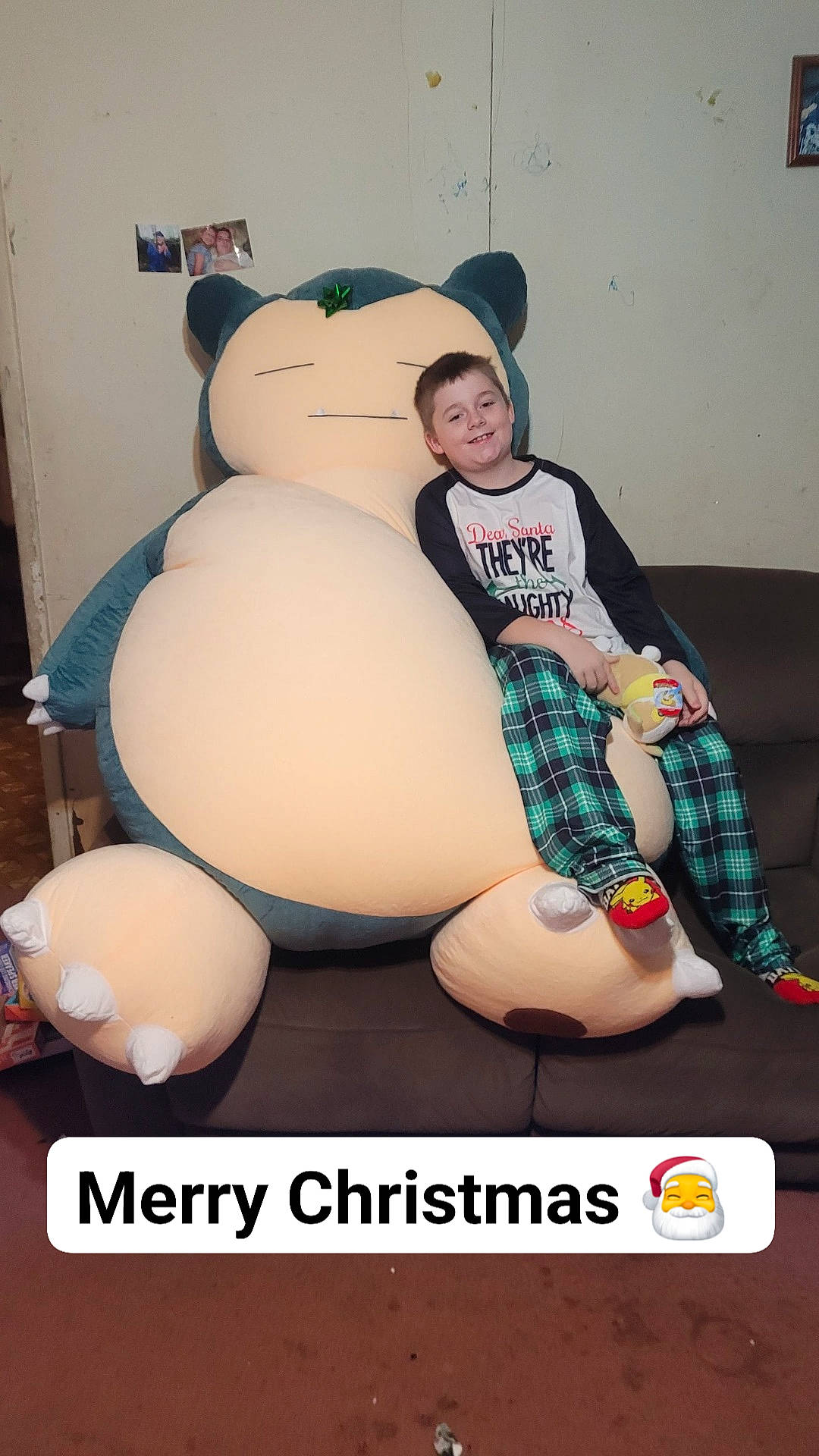 Blaze is registered to the contest to win money with this photo: abdomen, balloon, child, design, event, fictional_character, inflatable, joy, leg, pattern, person, personal_protective_equipment, plaid, plush, sitting, sock, stuffed_toy, t_shirt, teddy_bear, textile