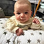 Leo is registered to the contest to win money with this photo: baby, infant, pillow, stars, clothing, pacifier_clip, hand, face, eyes, indoors, couch, blanket, sweater, cute, child, person, portrait, skin, expression, furniture