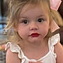 Reese is registered to the contest to win money with this photo: child, toddler, girl, face, lipstick, pink_bow, white_top, ruffles, indoor, blurry_background, hands, curly_hair, portrait, cute, young, person, expression, skin, hair, closeup