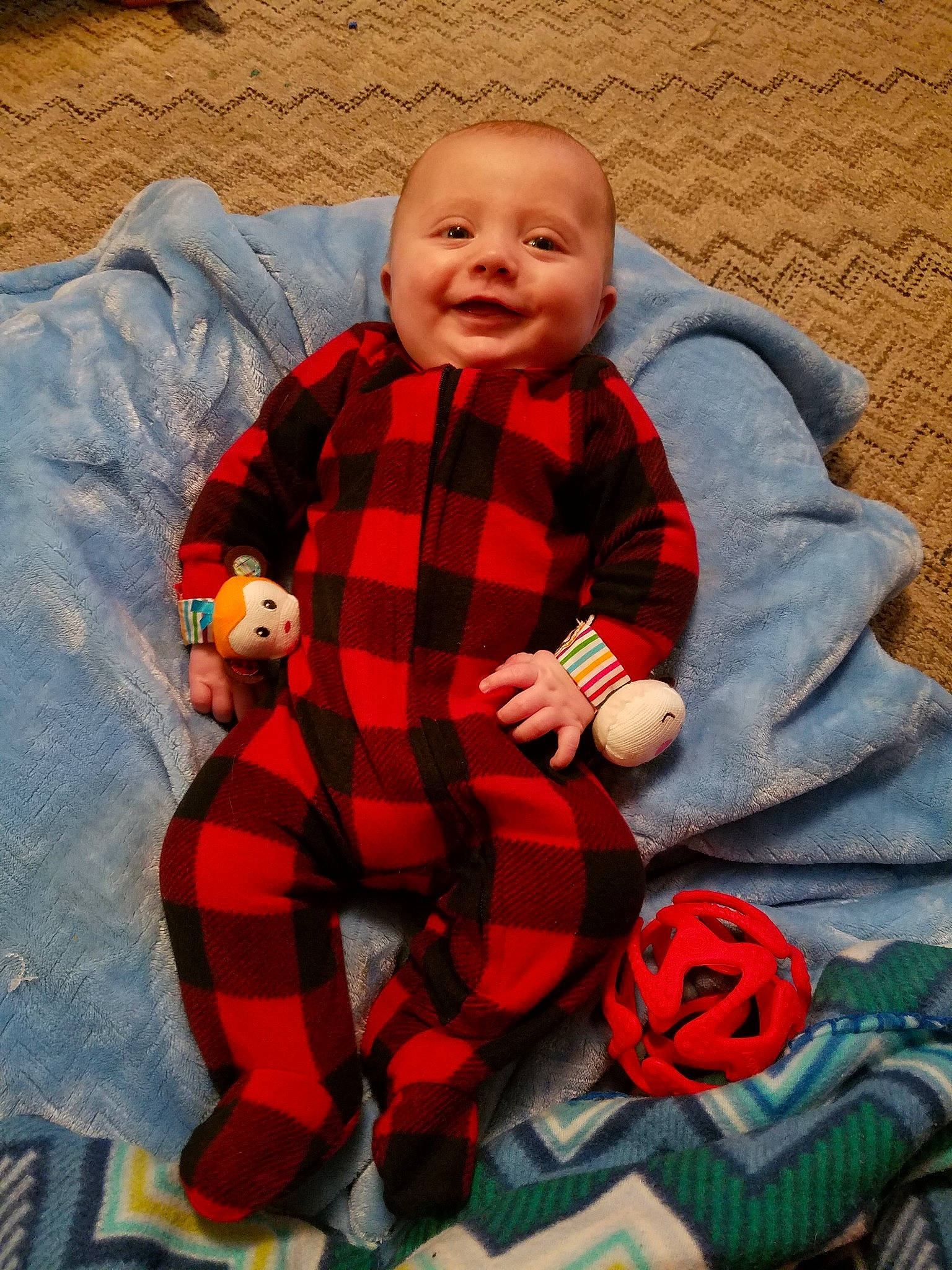 Bowie is registered to the contest to win money with this photo: boy, child, christmas, design, facial_expression, fun, holiday, infant, outerwear, pattern, person, plaid, play, red, sitting, skin, smile, standing, tartan, textile