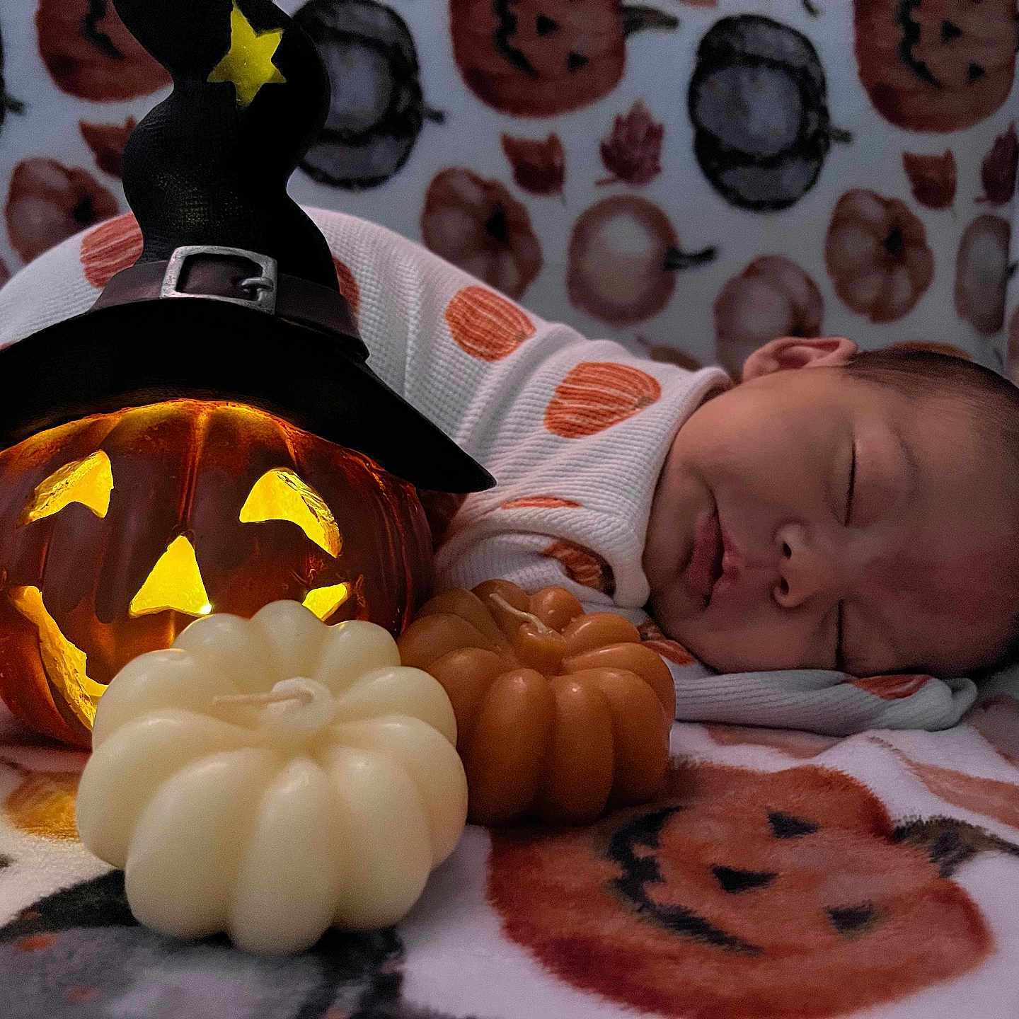 Nani is registered to the contest to win money with this photo: baby, blanket, candle, child, cozy, cute, decor, face, festive, halloween, holiday, infant, jack_o_lantern, lying_down, orange, pumpkin, sleeping, soft, white, witch_hat