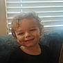 Maxton joined the competition — help win amazing prizes! black_tshirt, casual_clothing, child, couch, curly_hair, cute, dim, face, happy, home, indoor, kid, light, person, portrait, seated, smiling, toddler, window_blinds, young