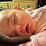 baby, blanket, child, closeup, cozy, face, furniture, hand, head, home, indoor, infant, mouth_open, peaceful, pink_sweater, portrait, relaxation, skin, sleeping, soft_light