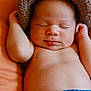 Samuel is registered to the contest to win money with this photo: newborn, baby, sleeping, knitted_hat, crochet, orange_cushion, infant, cute, peaceful, skin, hands, face, diaper_cover, cozy, relaxed, portrait, child, indoors, closeup, resting