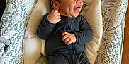 Samuel joined the competition — help win amazing prizes! baby, infant, smiling, black_onesie, bouncer, baby_bouncer, patterned_fabric, happy, indoor, wood_floor, child, cute, face, person, small_hands, head, joy, relaxed, seated, cozy