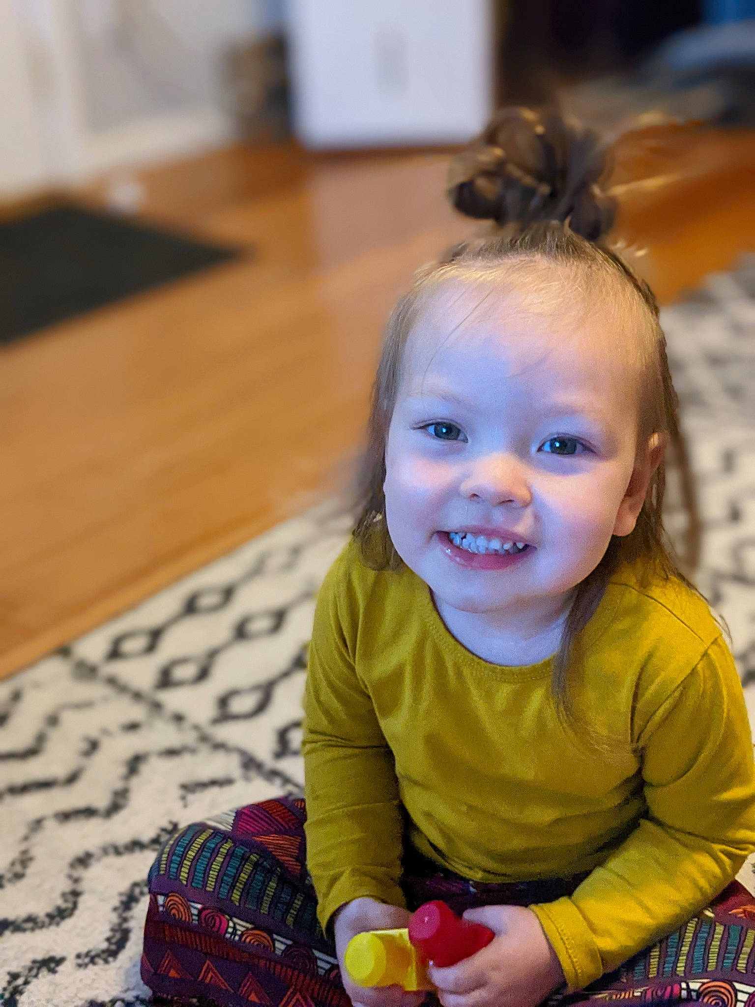 Ramona joined the competition — help win amazing prizes! baby, baby_playing_with_toys, baby_toddler_clothing, child, event, flooring, fun, happy, hardwood, iris, joy, leisure, party, pattern, person, play, sitting, skin, smile, toddler