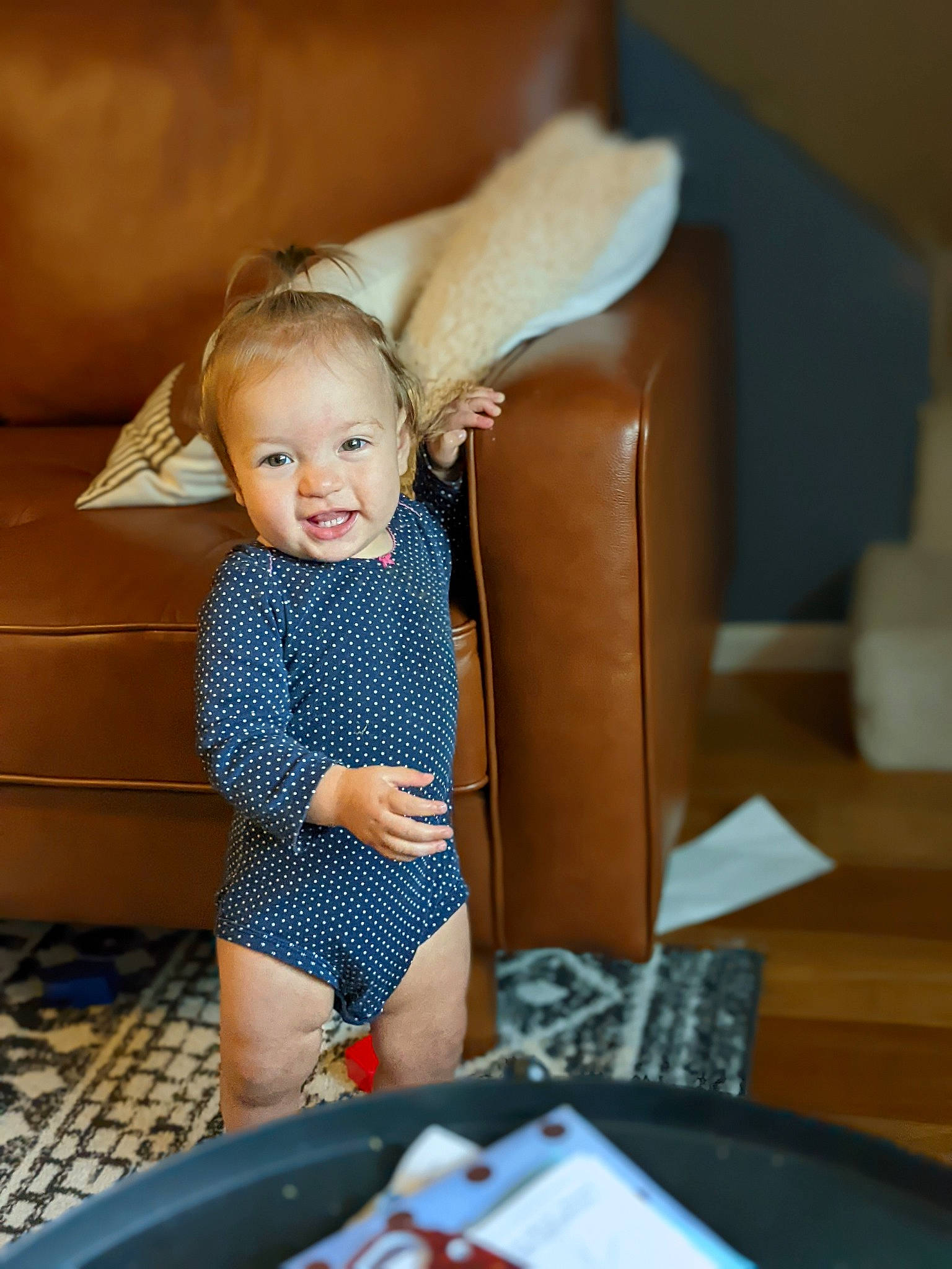 Brielle joined the competition — help win amazing prizes! baby, baby_toddler_clothing, child, comfort, couch, electric_blue, eye, flooring, fun, happy, human_body, human_leg, leisure, person, room, sitting, smile, table, thigh, toddler