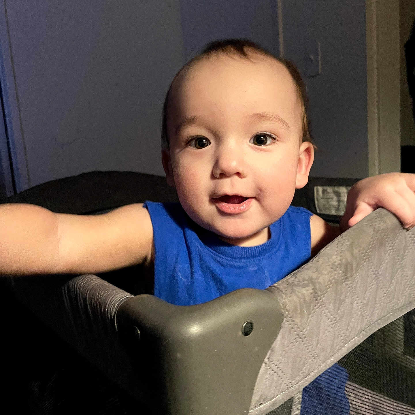Alejandro joined the competition — help win amazing prizes! toddler, child, blue_shirt, playpen, indoor, curious, face, arm, expression, person, baby, furniture, home, lighting, portrait, young_child, smile, skin, hair, room