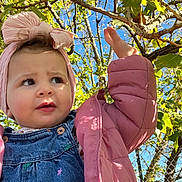 émilie participe au concours pour gagner de l'argent avec cette photo : baby, blue_sky, branches, child, curious_expression, cute, daytime, denim_overalls, fall_season, fence, headband, leafy_tree, nature, outdoor, person, pink_jacket, portrait, sunlight, toddler, young_child