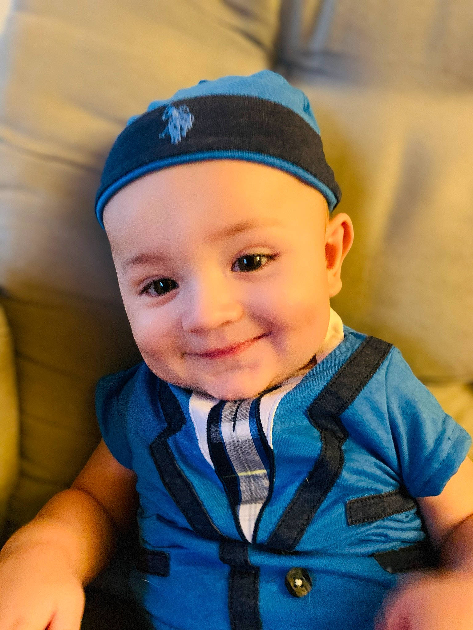 George is registered to the contest to win money with this photo: baby, baby_toddler_clothing, blue, cap, cheek, child, cool, eye, face, fashion_accessory, hat, head, headgear, headwear, joy, person, toddler