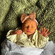 Orlagh joined the competition — help win amazing prizes! baby, newborn, sleeping, blanket, headband, bow, knitted_sweater, cozy, soft_texture, green_blanket, white_blanket, infant, peaceful, cute, portrait, hands, face, indoors, resting, child