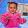 child, girl, smiling, outdoor, snow, winter, jacket, dress, skirt, hair_clips, blue_sky, trees, house, sunny, happy, portrait, person, daylight, cold, cute