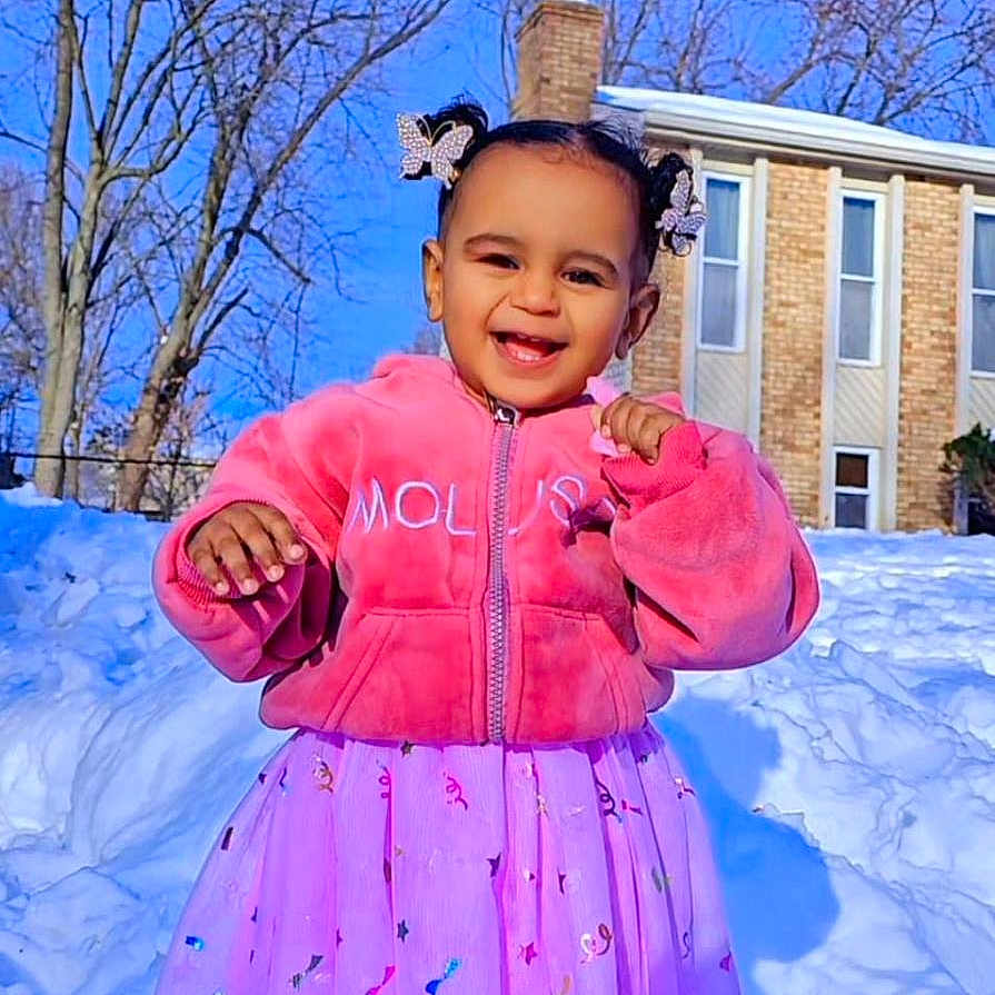 Ilaria joined the competition — help win amazing prizes! child, toddler, smiling, pink_jacket, skirt, snow, outdoor, winter, blue_sky, bare_trees, sneakers, hair_bows, happy, portrait, daylight, playful, fashion, cute, person, young_child